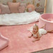 Baby crawling on the cushioned Dakota Rose Shwally Playmat