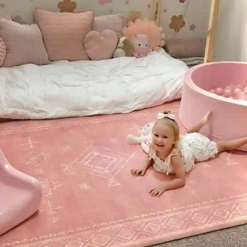 Baby crawling on the cushioned Dakota Rose Shwally Playmat