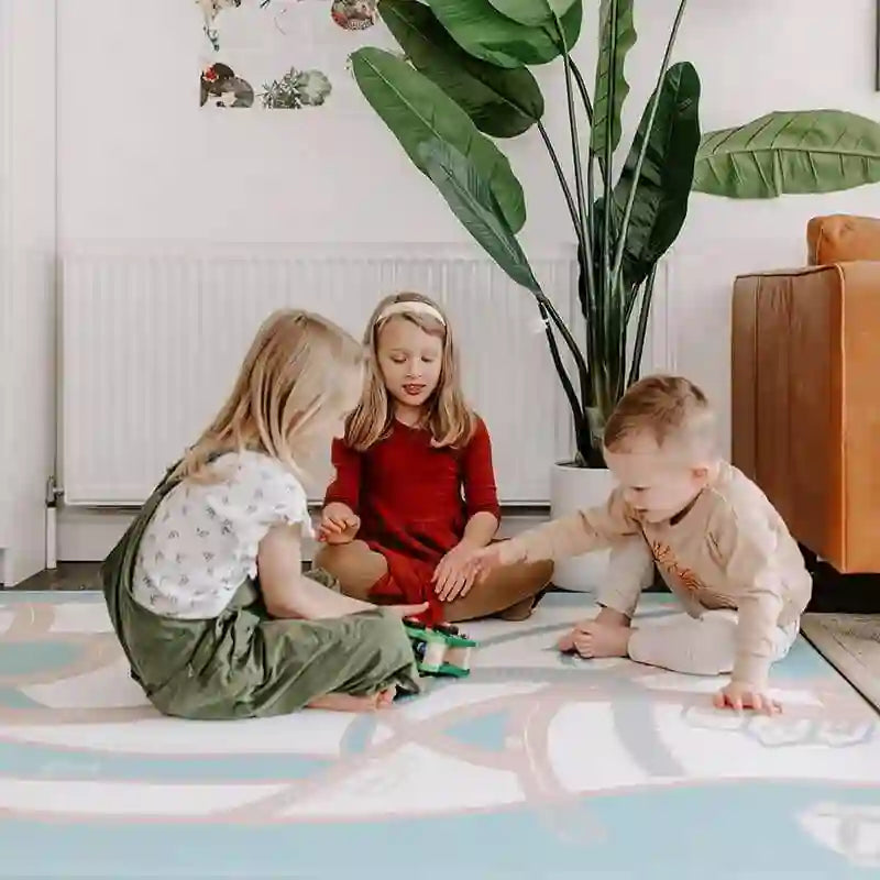 Three kids playing together on the Dakota Rose Shwally Playmat