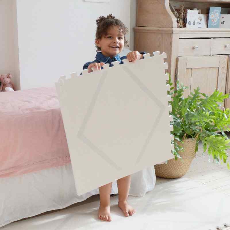 Eeveve Beni Cashmere Double Sided Play Mat with girl holding 