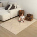 Eeveve Beni Cashmere Double Sided Play Mat in a living room with a baby