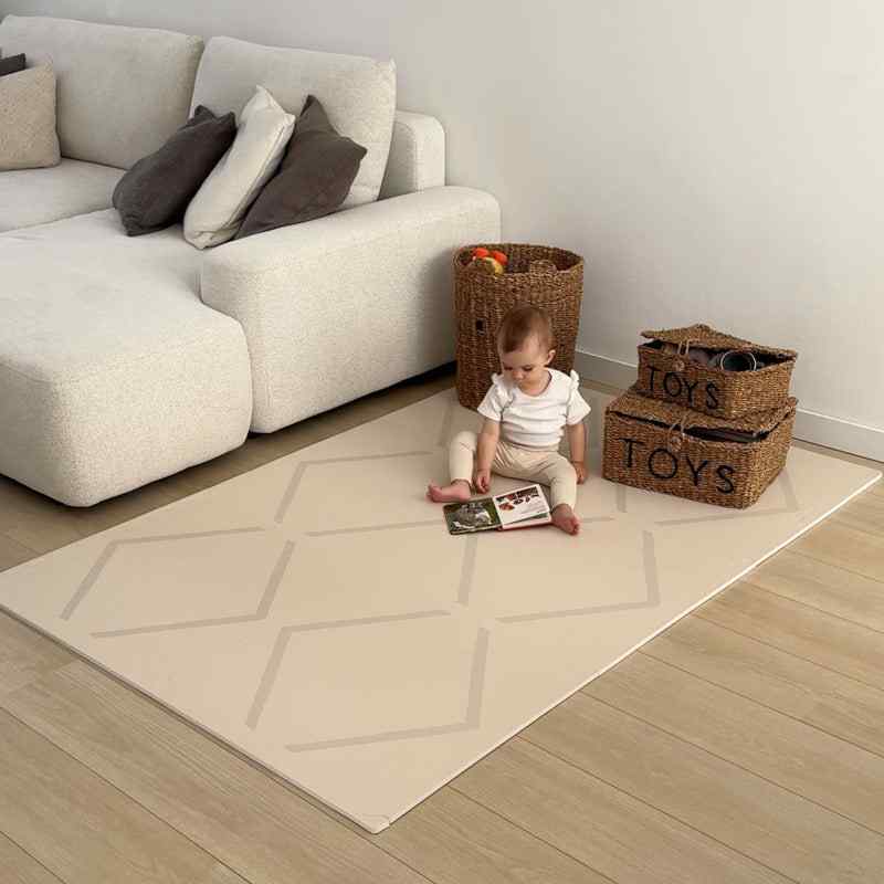 Eeveve Beni Cashmere Double Sided Play Mat in a living room with a baby