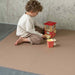 Eeveve Cinnamon Double Sided Play Mat with a toddler playing 