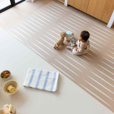 eeveve lucio desert sand double sided playmant with a baby