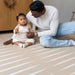 eeveve lucio desert sand double sided playmant with a toddler
