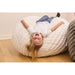Cloud Comfort Bean Bag (Small) – kid reclining on a Cream chair