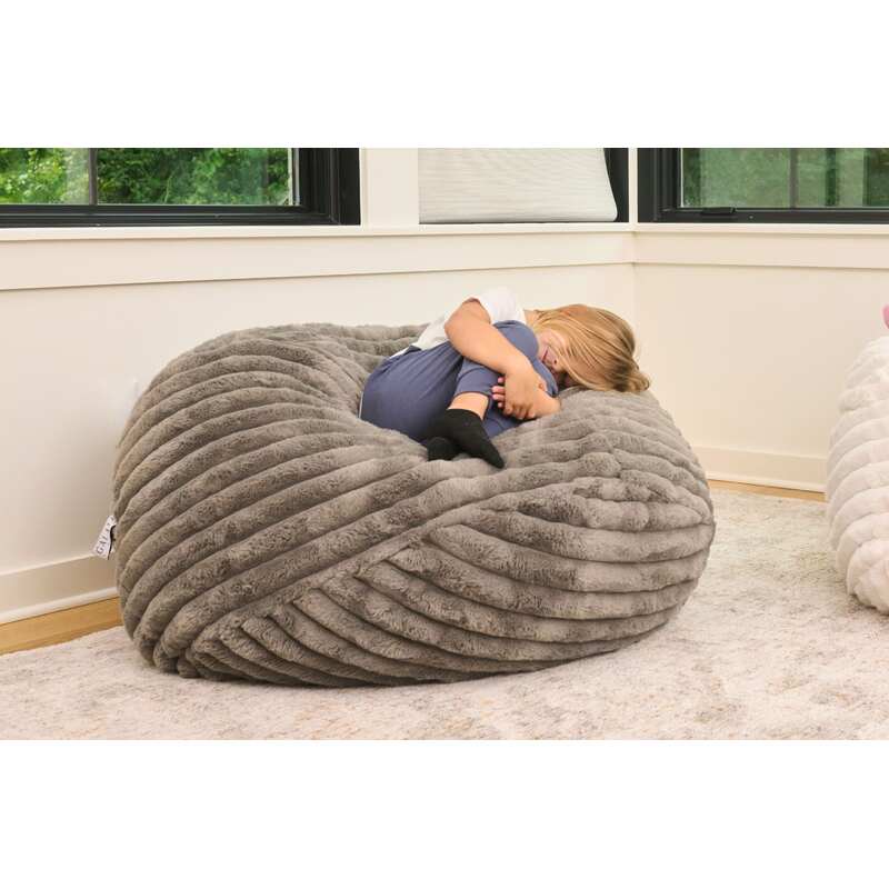 Cloud Comfort Bean Bag (Small) – kid curled up on a Grey chair