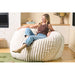Cloud Comfort Bean Bag (Standard) – adult sitting on a Cream faux fur corduroy chair
