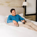 Crescent Backrest – adult reading in bed with a Space Gray backrest