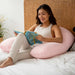 Crescent Backrest – adult reading in bed with a Rose Quartz backrest