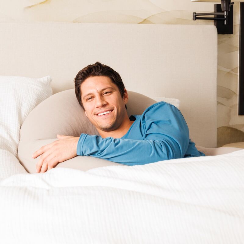 Crescent Backrest – adult reclining in bed with a Space Gray backrest