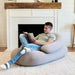 Moon Pod + Backrest Bundle – adult reading beside a fireplace on the two piece bundle