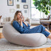 Moon Pod + Backrest Bundle – Space Gray seat in a living room with the backrest behind the reader