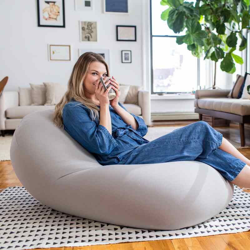Moon Pod + Backrest Bundle – Space Gray seat in a living room with the backrest behind the reader