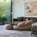 Moon Pod Bundle (Moon Pod + Backrest + Footrest) – adult reclining on the three piece set beside a sofa