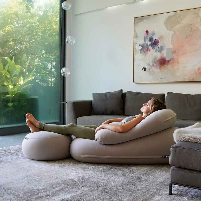 Moon Pod Bundle (Moon Pod + Backrest + Footrest) – adult reclining on the three piece set beside a sofa