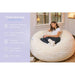 Cloud Comfort Bean Bag (Standard) – Standard chair features beside an adult sitting in Cream
