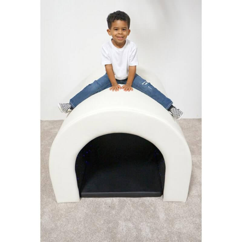 Child climbing on top of the Experia Fiber Optic Tranquility Sensory Tunnel