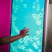 Experia IntelliTouch Bubble Wall Panel – hand interacting with aqua bubbles