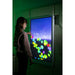 Child interacting with colorful candy-shaped effects on the Experia IntelliTouch Particle Panel