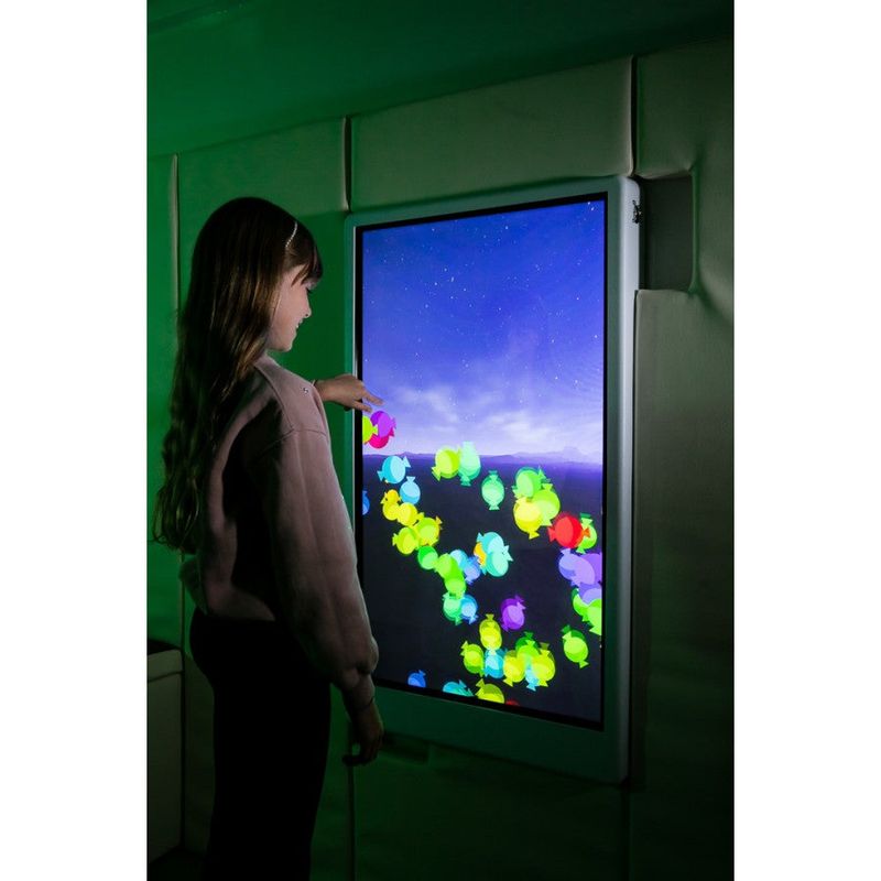 Child interacting with colorful candy-shaped effects on the Experia IntelliTouch Particle Panel