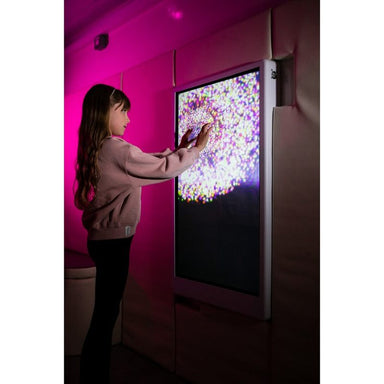 Child exploring multicolored light particles with both hands on the Experia IntelliTouch Particle Panel