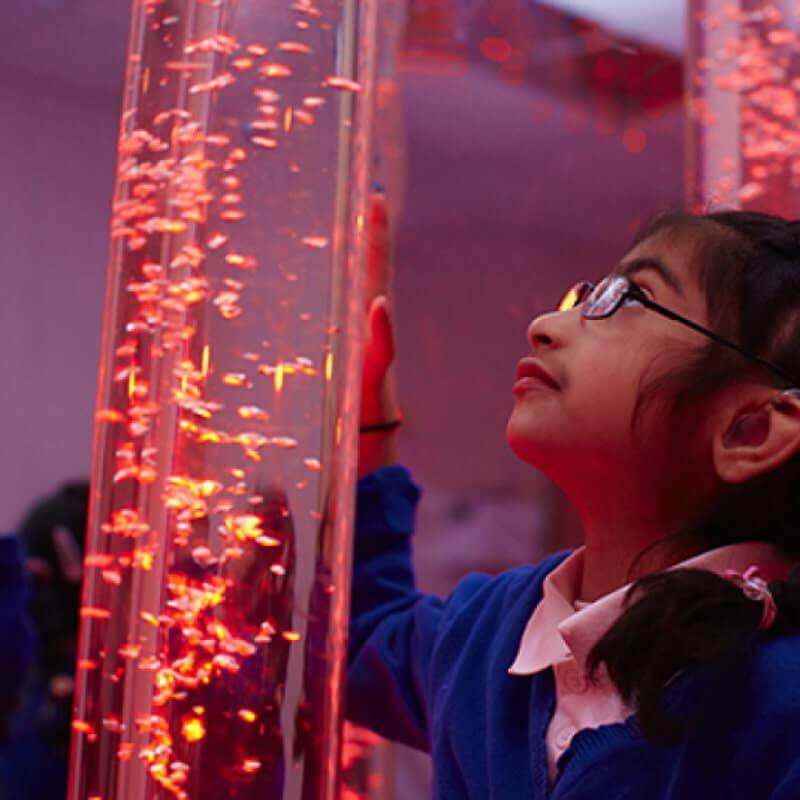 Child using the touch controls on the Experia Touch Sensitive LED Bubble Tube