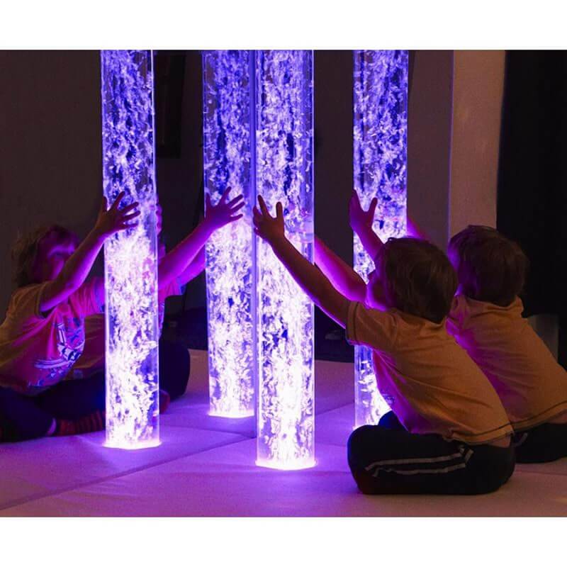 Child watching the bubble tube in the Experia Underwater Adventure Sensory Room Bundle