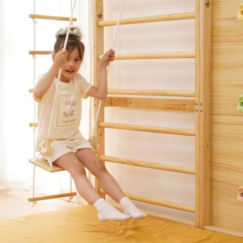 Girl Happily Swings on a Swing in the Avenlur 9-in-1 Indoor Playground Room