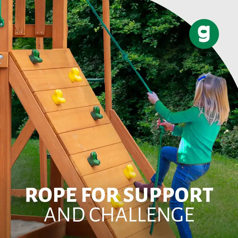 Gorilla Playsets Empire Swing Set – child climbing the rock wall with the support rope