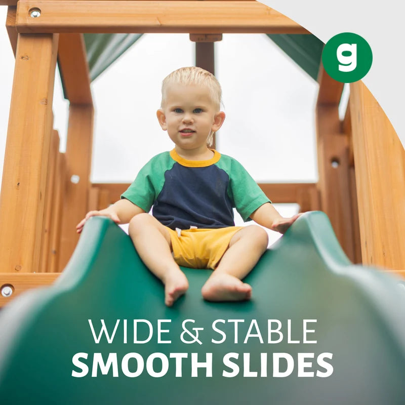 Gorilla Playsets Empire Swing Set – child sitting at the top of the Alpine Wave Slide