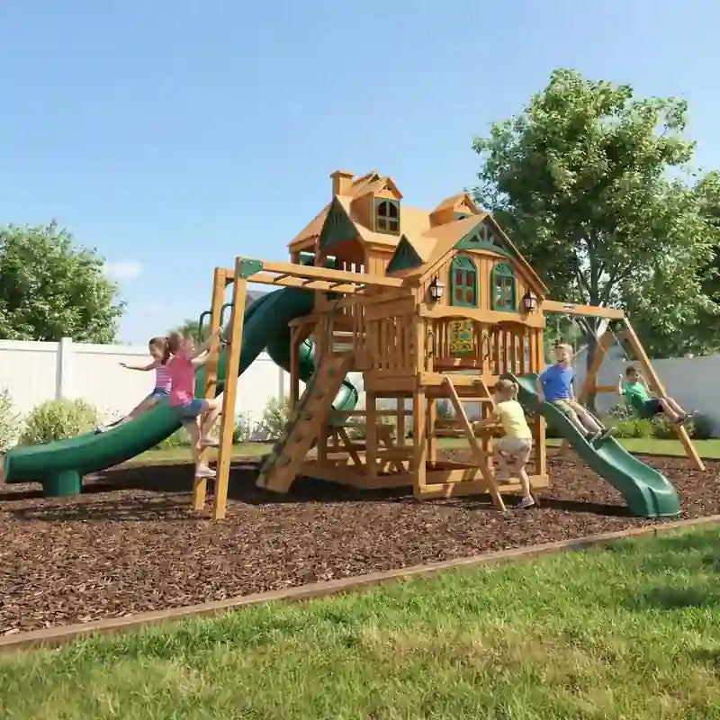 Gorilla Playsets Empire Swing Set – kids playing on the three-slide clubhouse and swings