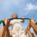 Gorilla Playsets Summerville Deluxe Swing Set – child holding the horizontal climbing bar