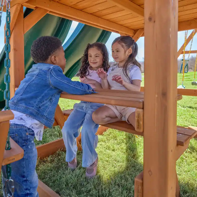 Gorilla Playsets Summerville Deluxe Swing Set – children playing at the built-in picnic table