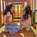 Gorilla Playsets Summerville Deluxe Swing Set – children playing tic-tac-toe inside the clubhouse
