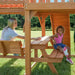 Gorilla Playsets Summerville Swing Set – adult and child at the built-in picnic table
