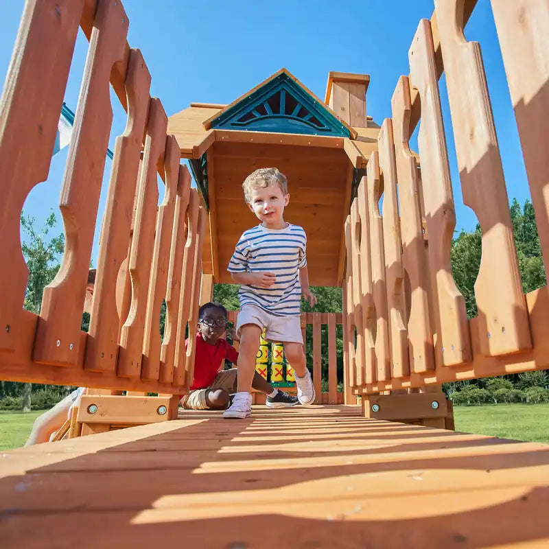 Gorilla Playsets Summerville Swing Set – child walking along the upper play deck