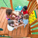 Gorilla Playsets Summerville Swing Set – children playing together inside the clubhouse