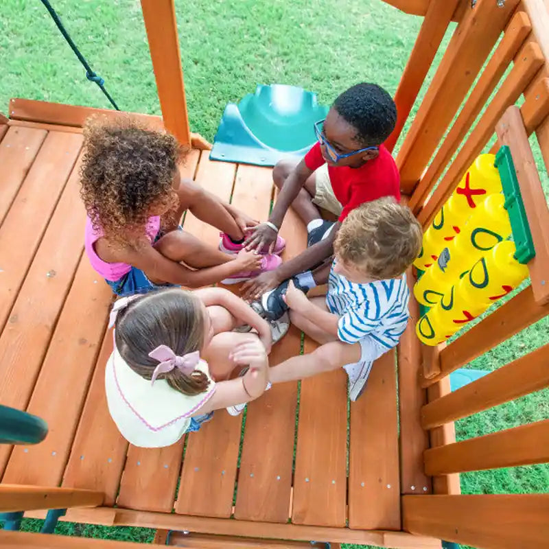Gorilla Playsets Summerville Swing Set – children playing together inside the clubhouse