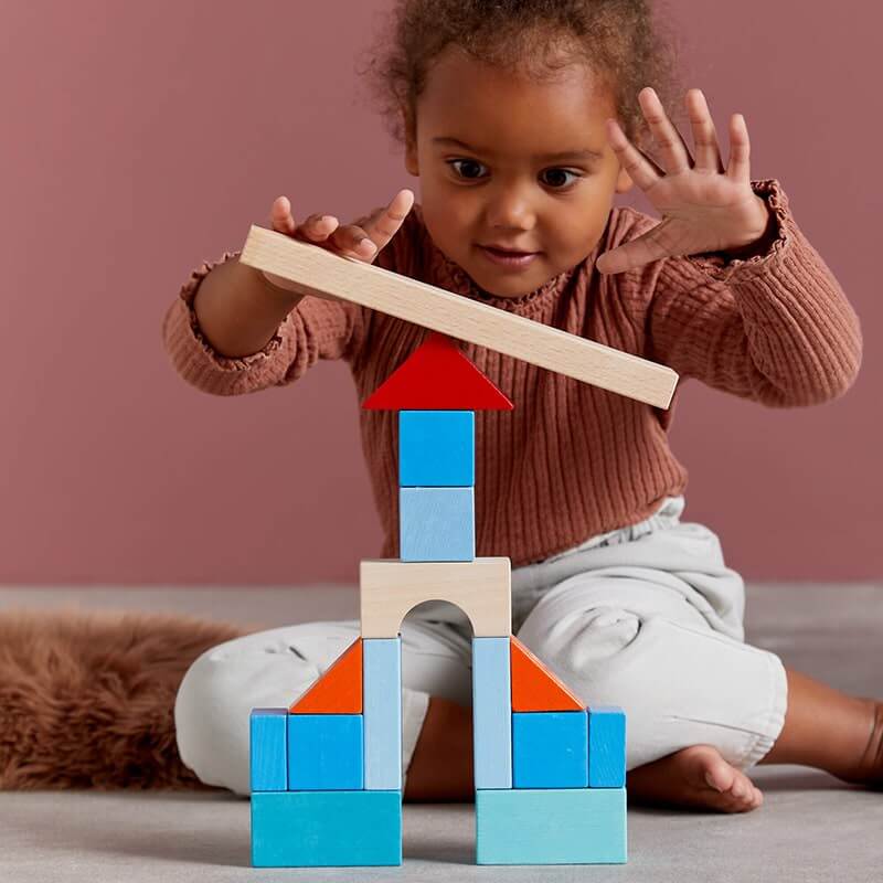 HABA Colored Wooden Building Blocks - 46 Piece Set – child building with colorful blocks