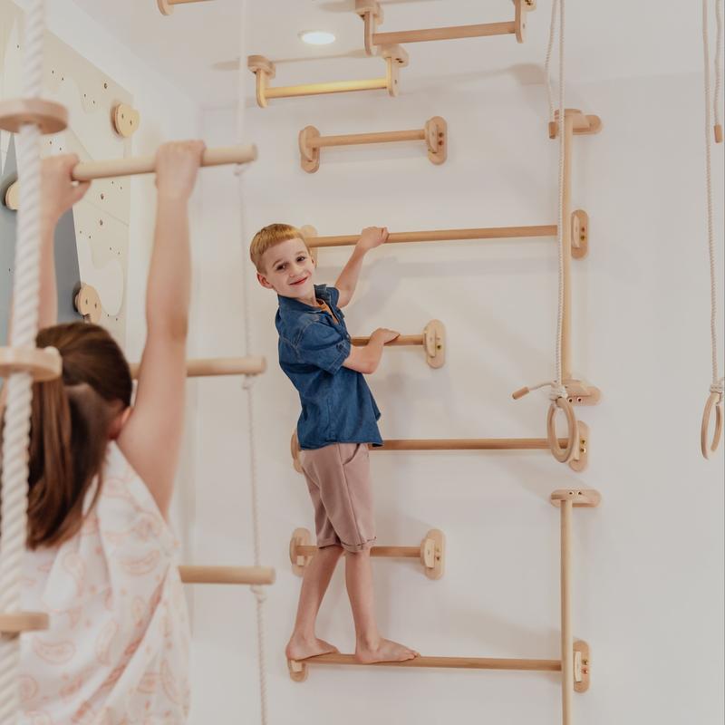 Home Monkey Bars – kid climbing long bars with an adult nearby