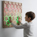 Honeycomb Touch Interactive Panel - child following green and pink light patterns