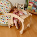 Kidodido Toddler Rocking Chair and Table Set Child Playing With a Wooden Toy