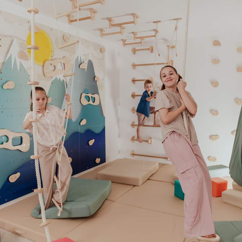 Kids Climbing Ropes – kid using wooden spheres on the climbing rope