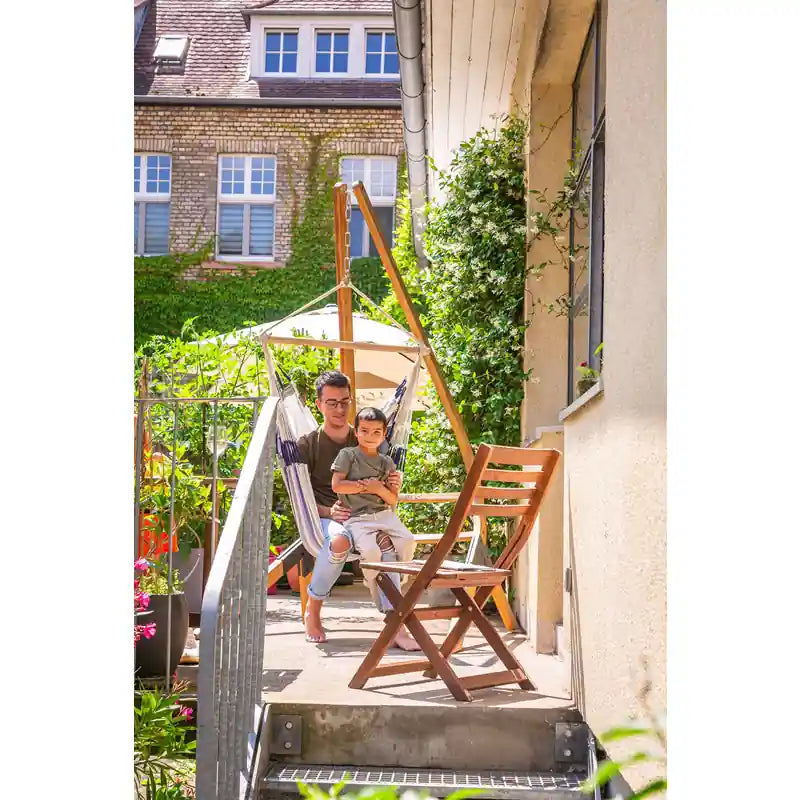 Domingo Sea Salt - Weather-Resistant Basic Hammock Chair – person seated on a balcony with a separate stand