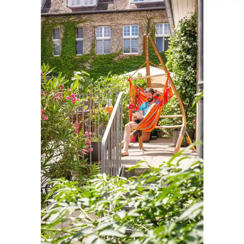 Domingo Toucan - Weather-Resistant Basic Hammock Chair – person relaxing beside balcony greenery
