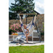 Domingo Sea Salt - Weather-Resistant Comfort Hammock Chair – seated user on a patio with a separate stand