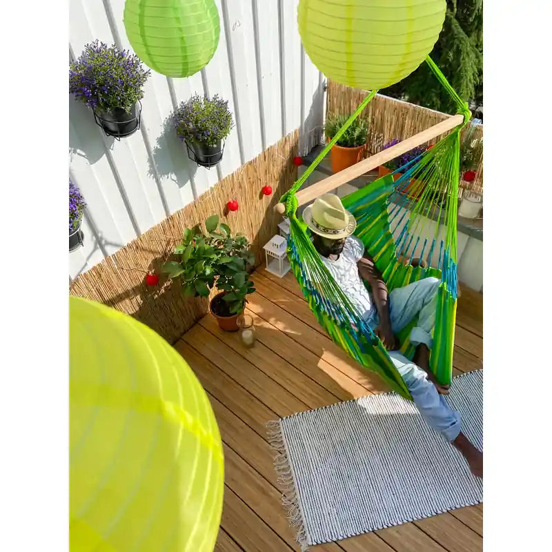 Domingo Lime - Weather-Resistant Comfort Hammock Chair – person seated on a decorated balcony