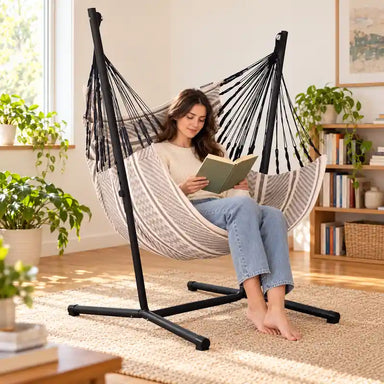 Fiji Organic Zebra – Organic Cotton Basic Size Hammock Chair with Galvanized Steel Stand – lifestyle illustration of adult reading in the hammock chair in a family reading room