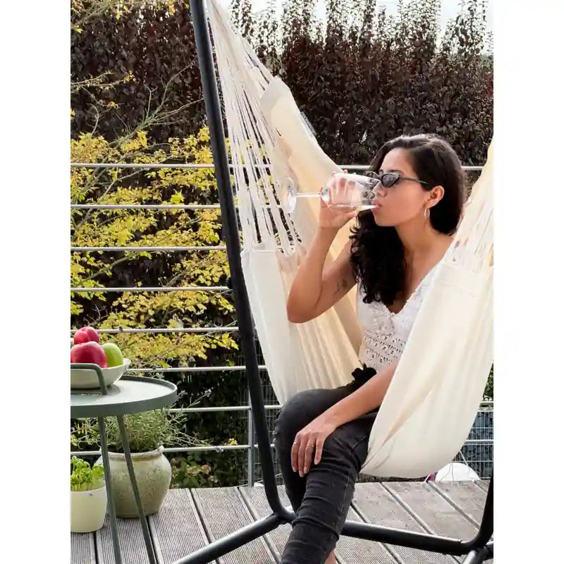 Fiji Organic Latte – Organic Cotton Comfort Size Hammock Chair with Galvanized Steel Stand – person seated on a balcony